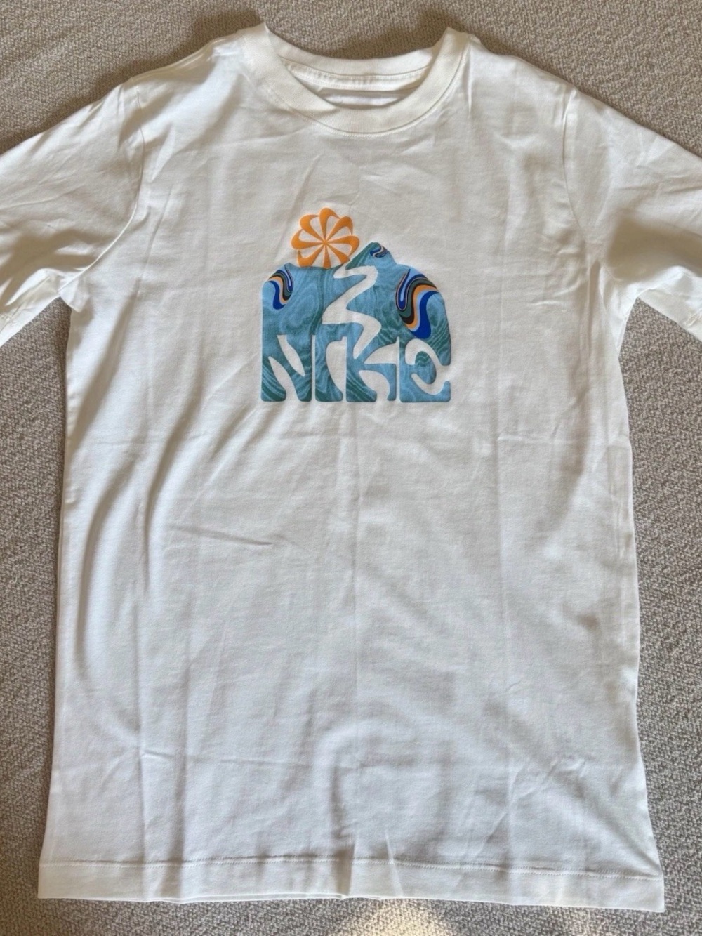 Nike White Tee with Blue Wave Logo and Orange Sun Accent